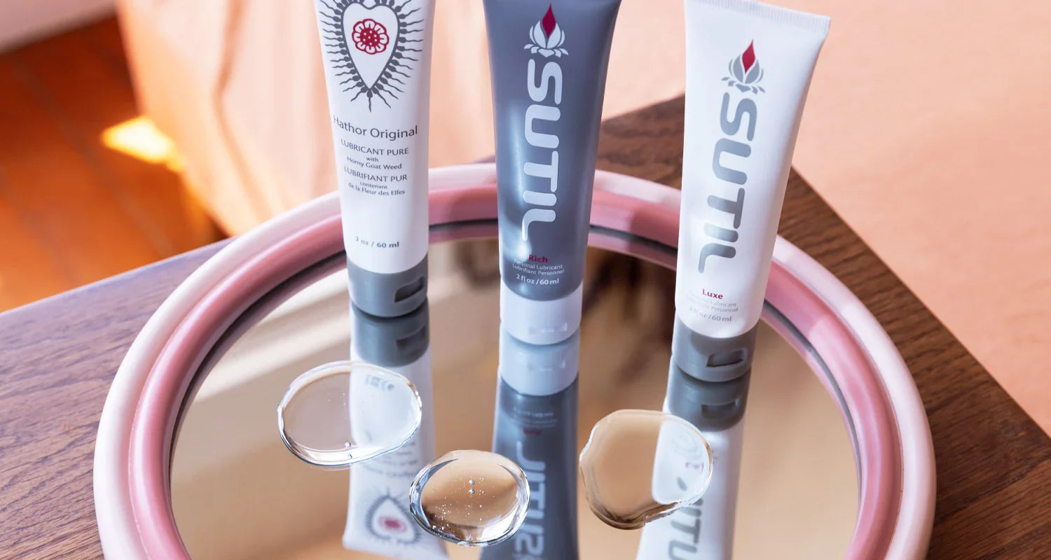 Three Sutil Lubricant displayed on a mirror, including Rich, Luxe and Pure